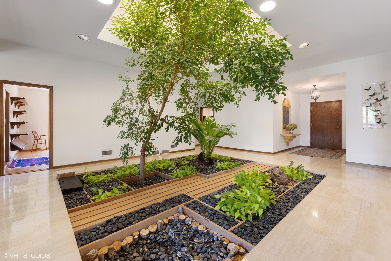 Live Plants and original travertine marble grace this Biophlic entry built and designed in the 1960's 